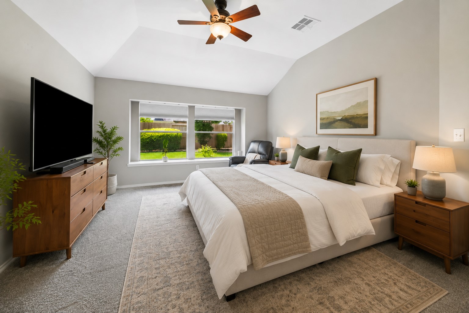 3118 Valley Court Manvel, TX 77578 - Photo 13 of 38 Spacious virtual staged bedroom with neutral tones, featuring a large bed, modern furniture, and a ceiling fan. It has a big window overlooking a garden, providing plenty of natural light.