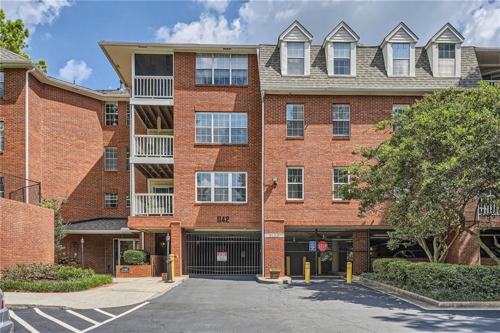 1142 North Jamestown Road, Unit 301 Decatur, GA 30033 - Photo 1 of 1 a front view of a building with a yard
