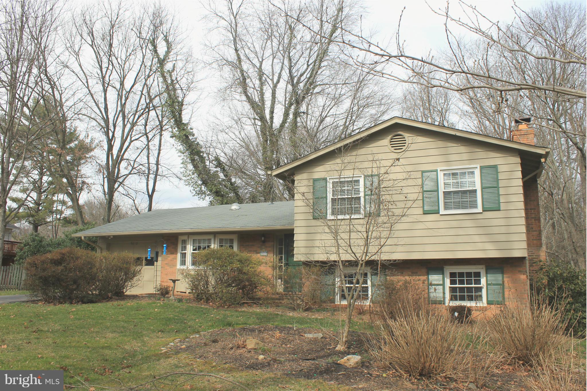 9810 Vale Road Vienna, VA 22181 - Photo 1 of 30 a front view of a house with a yard and garage