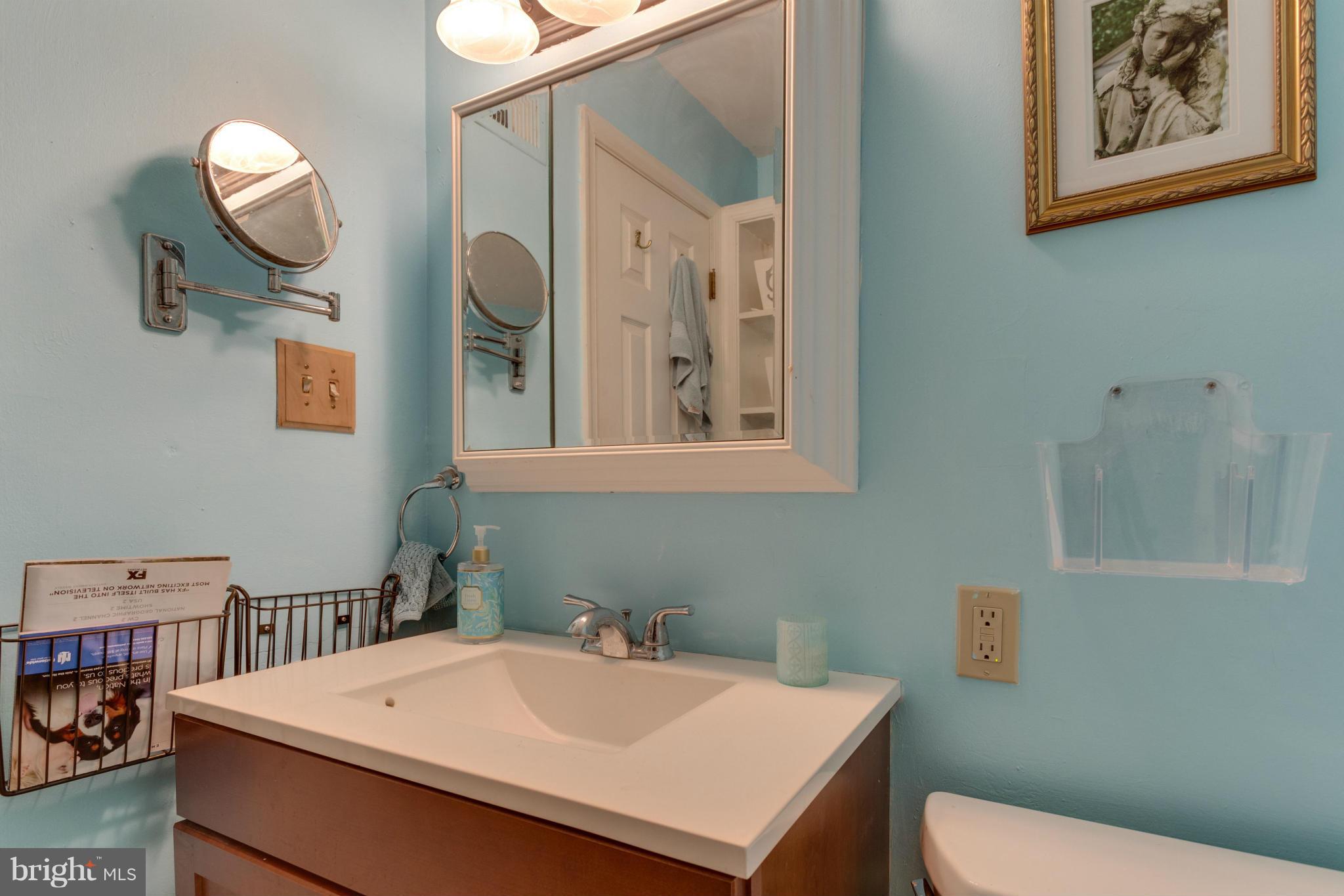 9810 Vale Road Vienna, VA 22181 - Photo 12 of 30 a bathroom with a sink mirror vanity and toilet