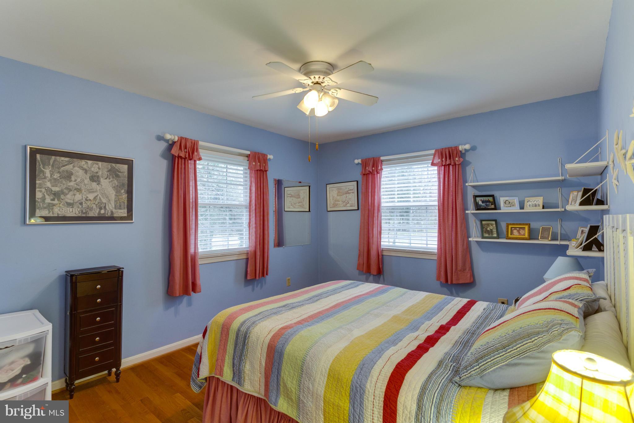 9810 Vale Road Vienna, VA 22181 - Photo 14 of 30 a bedroom with a bed and a chandelier
