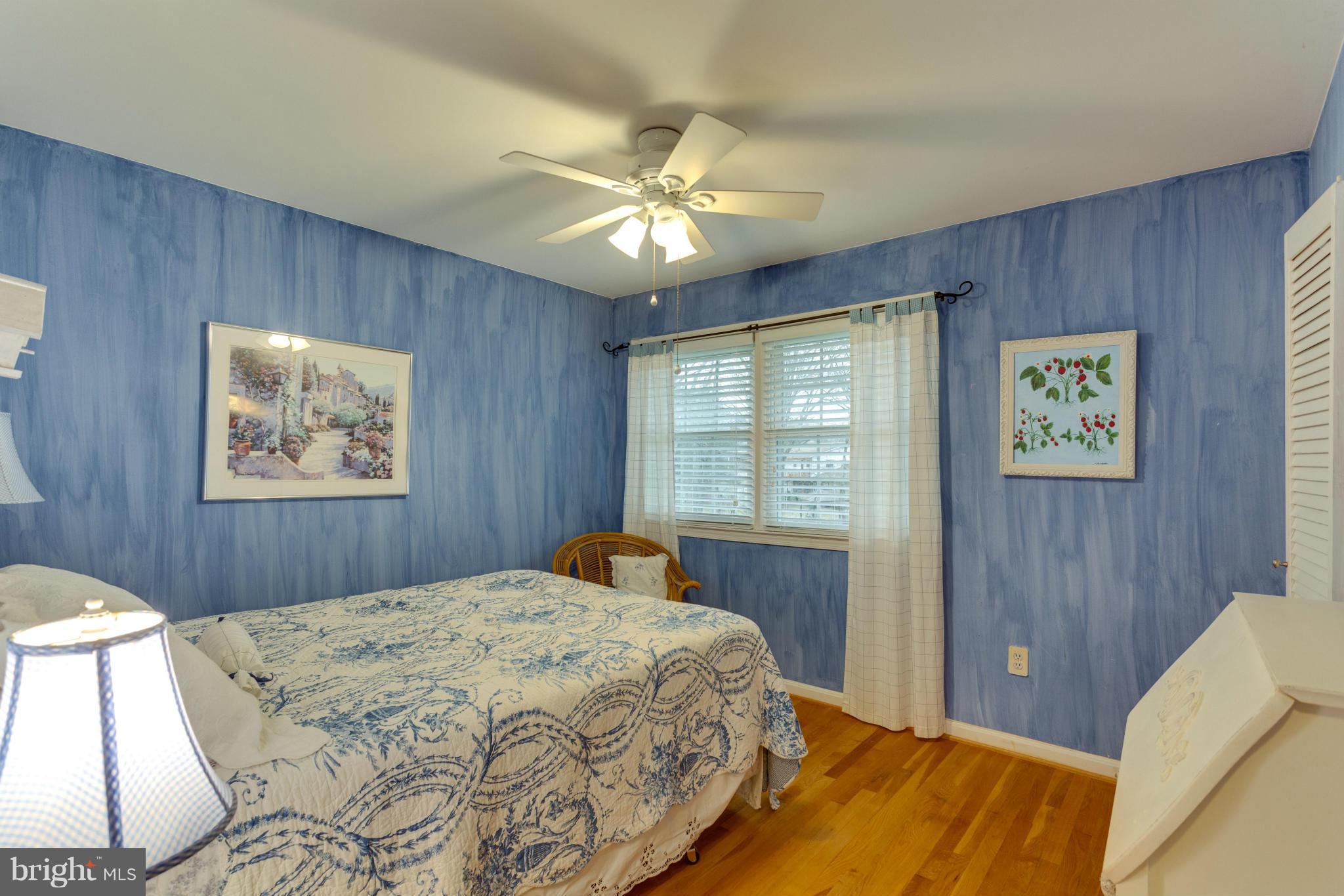 9810 Vale Road Vienna, VA 22181 - Photo 15 of 30 a bedroom with a large bed and a chandelier