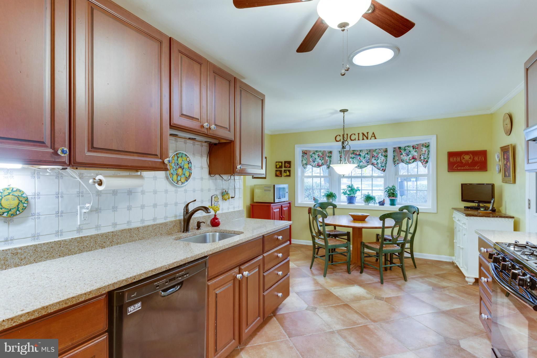 9810 Vale Road Vienna, VA 22181 - Photo 22 of 30 a open kitchen with stainless steel appliances granite countertop a sink a stove and a wooden floors