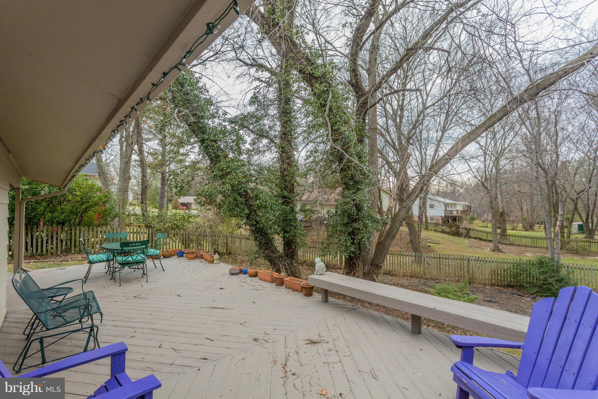 9810 Vale Road Vienna, VA 22181 - Photo 27 of 30 a view of backyard with a table and chairs and floor to ceiling window