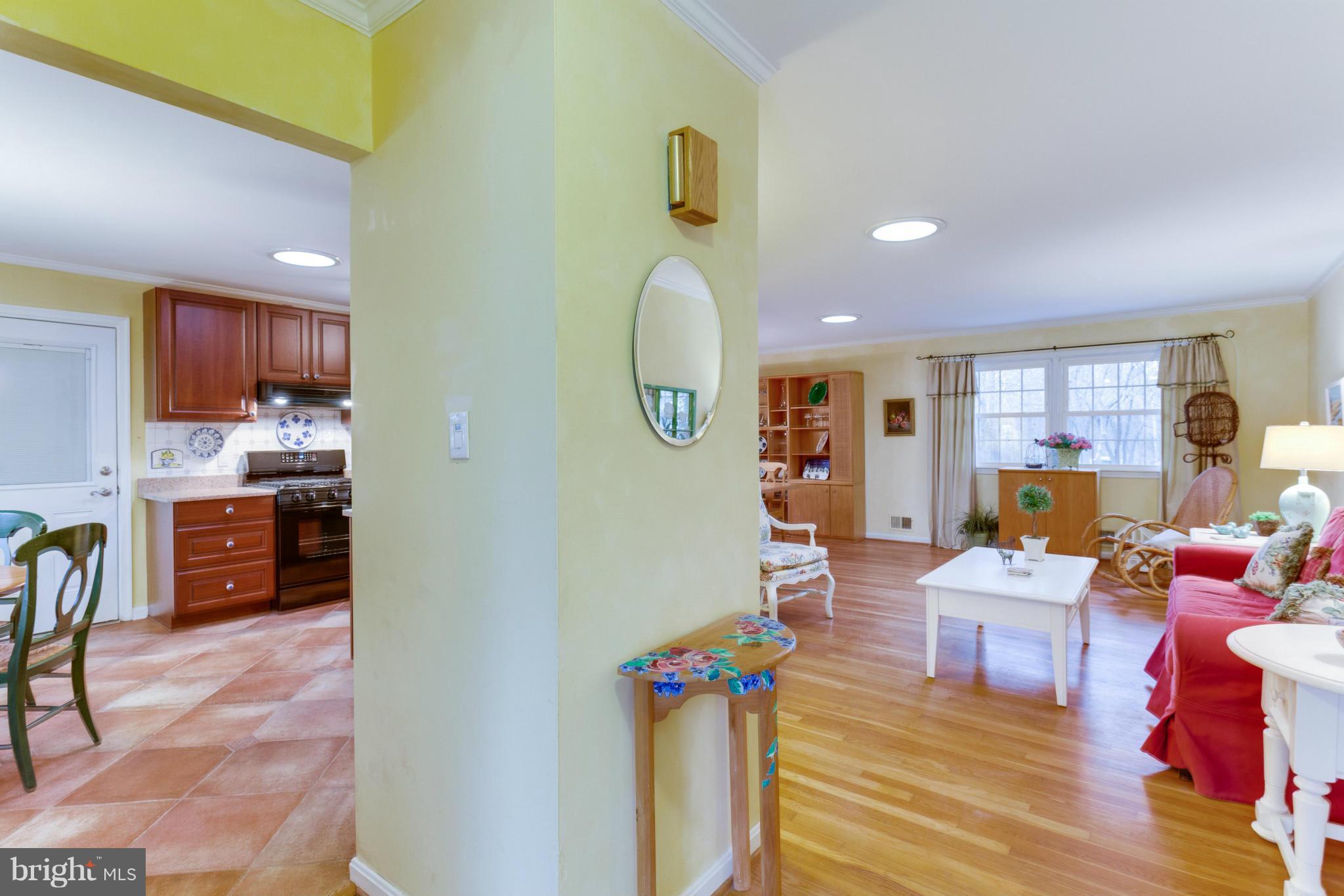 9810 Vale Road Vienna, VA 22181 - Photo 29 of 30 a living room with furniture a chandelier and a dining table