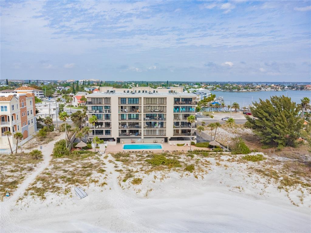 13650 Gulf Boulevard, Unit 402 Madeira Beach, FL 33708 - Photo 1 of 44 a view of building with ocean view