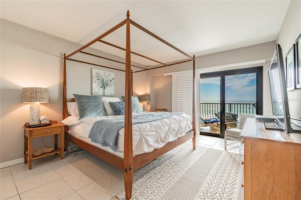 13650 Gulf Boulevard, Unit 402 Madeira Beach, FL 33708 - Photo 14 of 44 a bedroom with a bed and large window