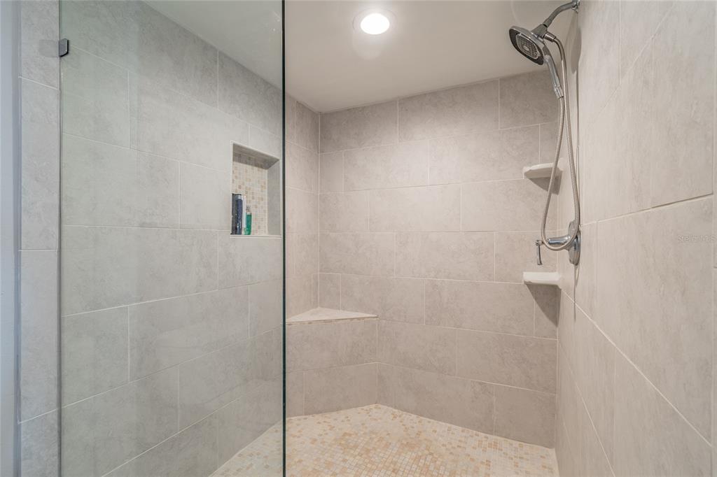 13650 Gulf Boulevard, Unit 402 Madeira Beach, FL 33708 - Photo 19 of 44 a bathroom with a shower