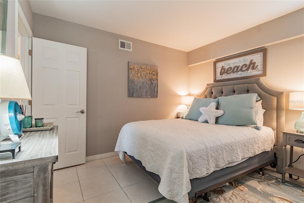 13650 Gulf Boulevard, Unit 402 Madeira Beach, FL 33708 - Photo 21 of 44 a bedroom with a bed and a couch