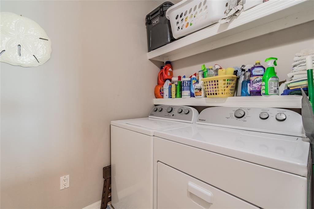 13650 Gulf Boulevard, Unit 402 Madeira Beach, FL 33708 - Photo 30 of 44 a utility room with dryer and washer