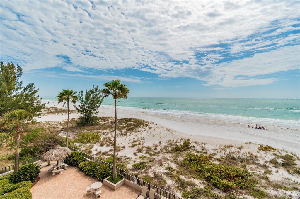 13650 Gulf Boulevard, Unit 402 Madeira Beach, FL 33708 - Photo 32 of 44 a view of a beach with a yard