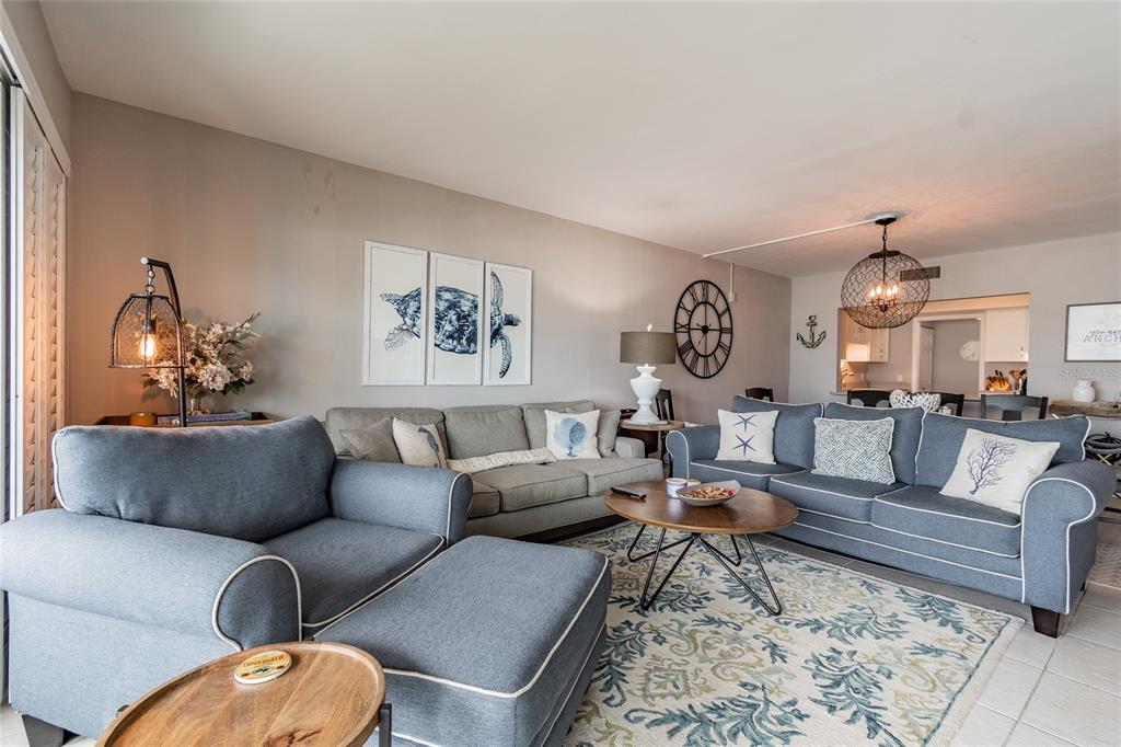 13650 Gulf Boulevard, Unit 402 Madeira Beach, FL 33708 - Photo 4 of 44 a living room with furniture and a rug