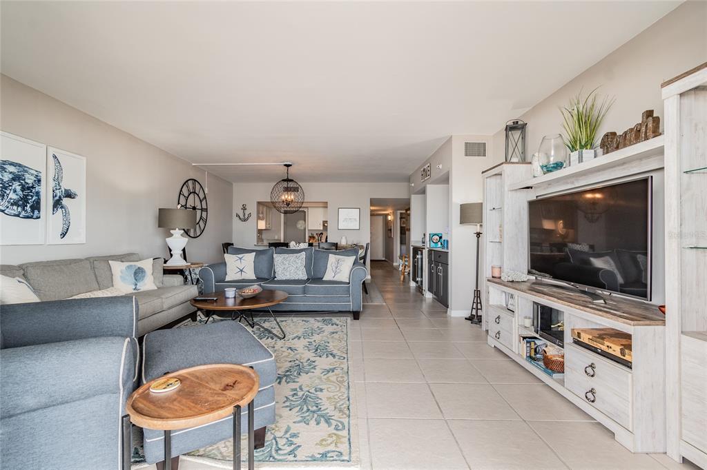 13650 Gulf Boulevard, Unit 402 Madeira Beach, FL 33708 - Photo 5 of 44 a living room with furniture and a flat screen tv