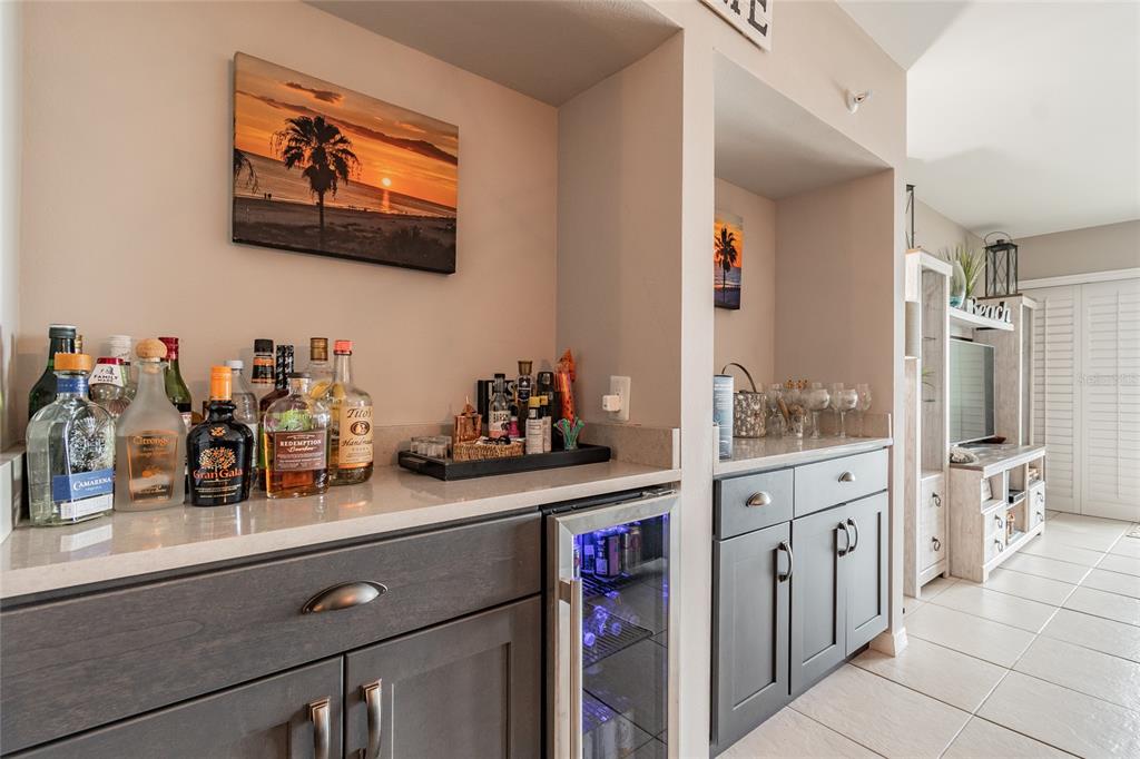 13650 Gulf Boulevard, Unit 402 Madeira Beach, FL 33708 - Photo 6 of 44 a kitchen with stainless steel appliances white cabinets and wooden floor