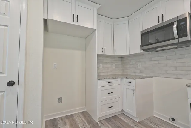 a kitchen with kitchen island a sink stainless steel appliances and a counter top space