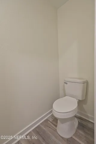 an empty room with a ceiling fan and a window