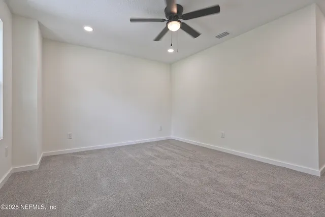 a bathroom with a granite countertop toilet sink and mirror