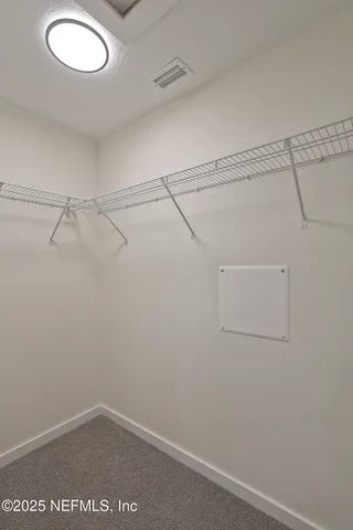 a view of a room with wooden floor and window