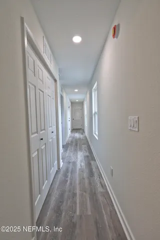 a bathroom with a granite countertop toilet a sink and a mirror