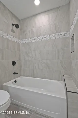 a view of a room with wooden floor and window