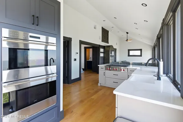 a large white kitchen with stainless steel appliances