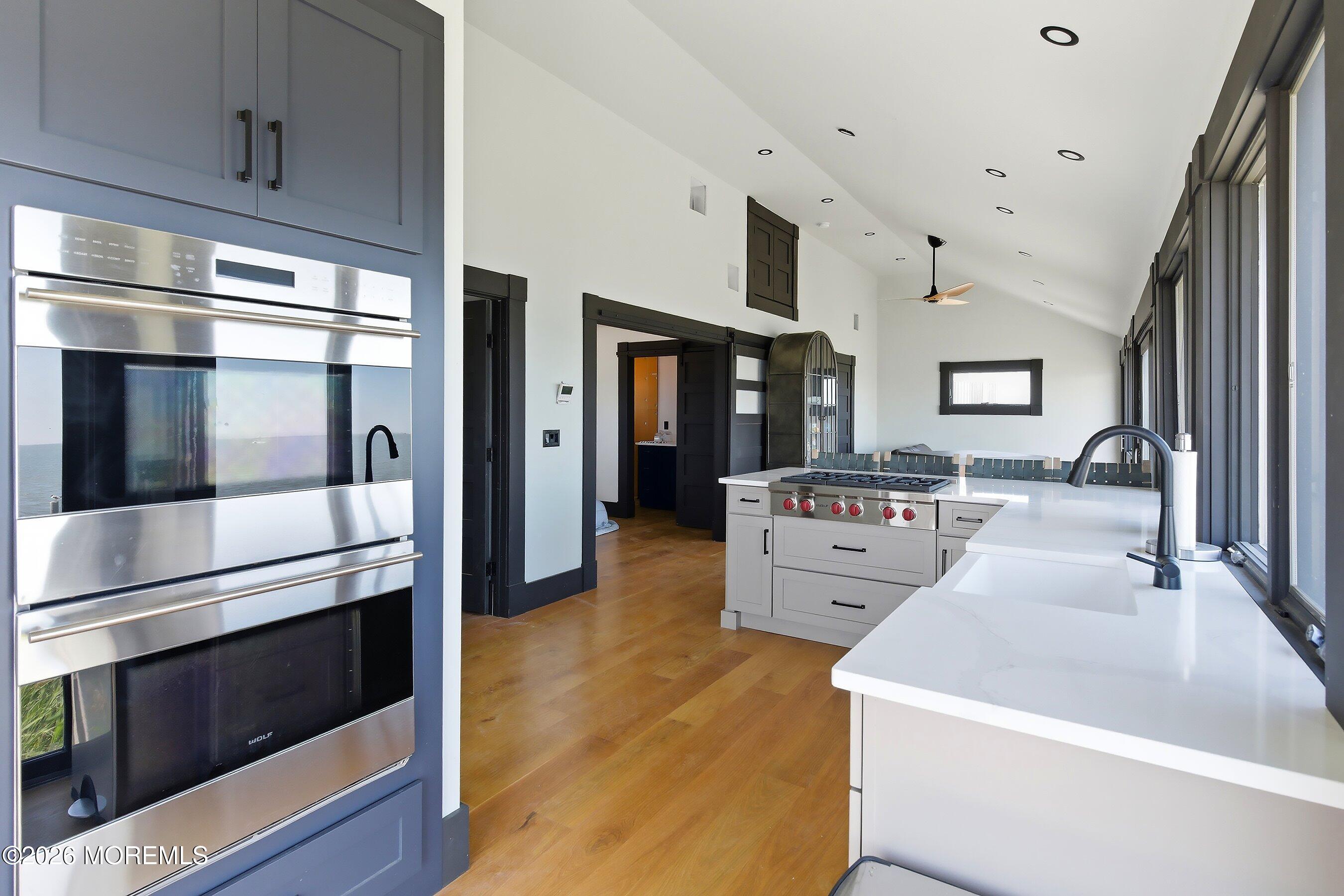 a large white kitchen with stainless steel appliances