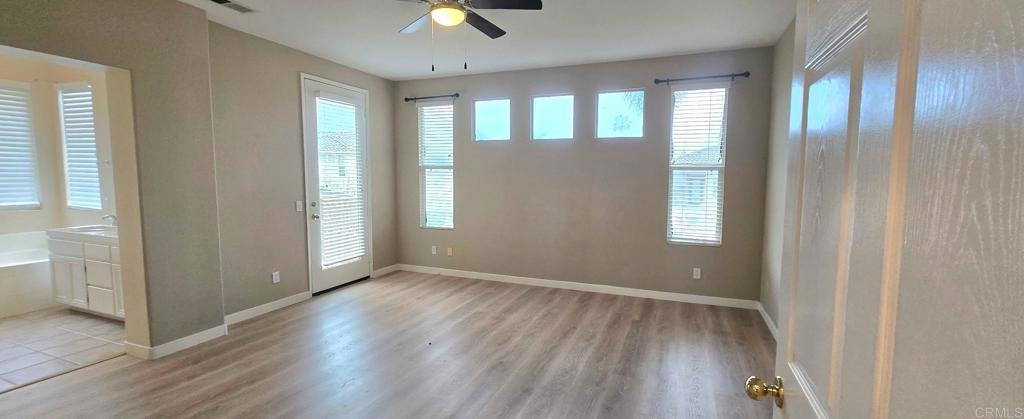 5071 Avocado Park Way Fallbrook, CA 92028 - Photo 3 of 7 an empty room with wooden floor and windows