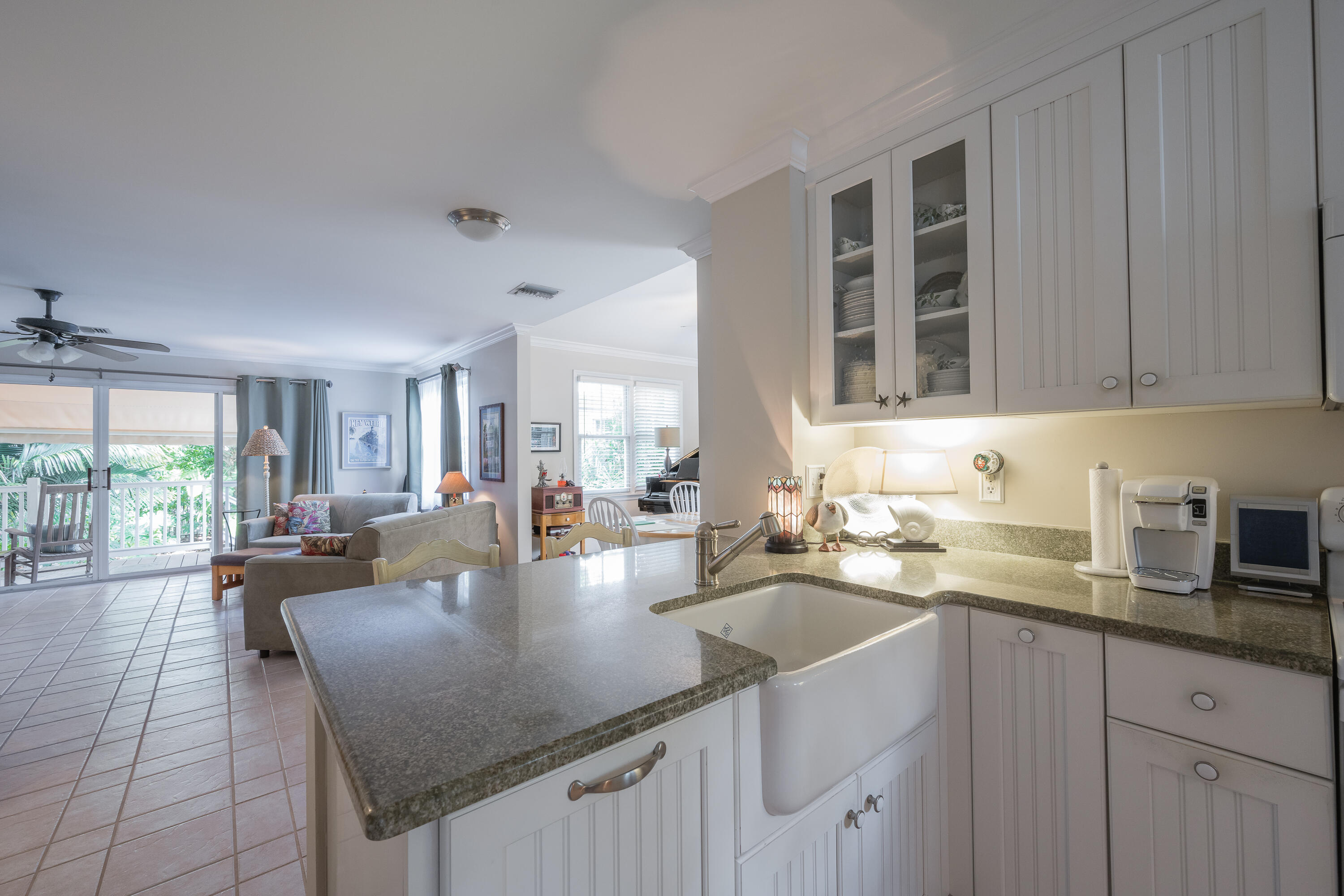 28 Spoonbill Way Key West, FL 33040 - Photo 12 of 82 a kitchen with a sink dishwasher a stove and white cabinets with wooden floor