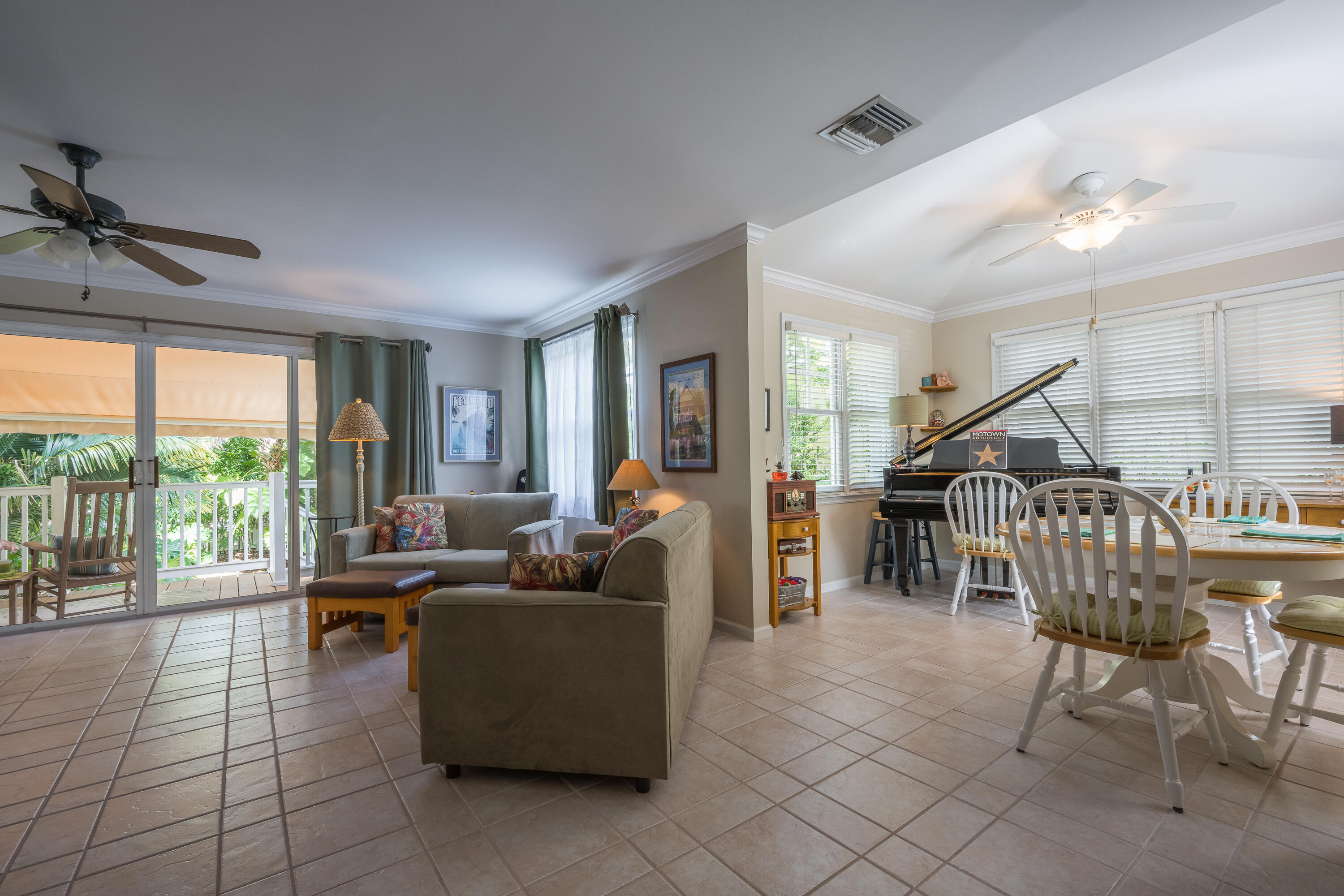 28 Spoonbill Way Key West, FL 33040 - Photo 19 of 82 a living room with furniture a floor to ceiling window and a ceiling fan