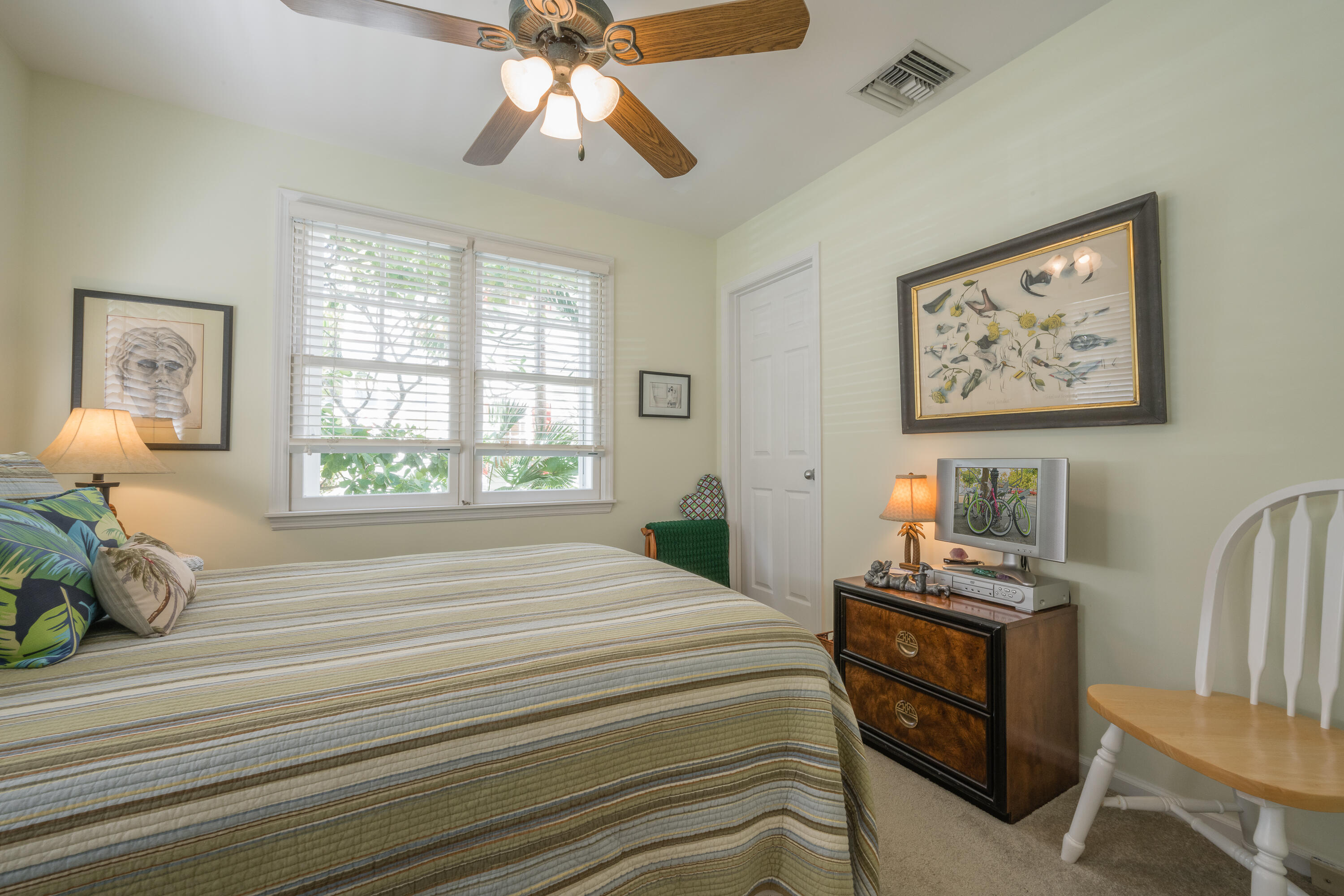 28 Spoonbill Way Key West, FL 33040 - Photo 8 of 82 a bedroom with a bed and wooden floor