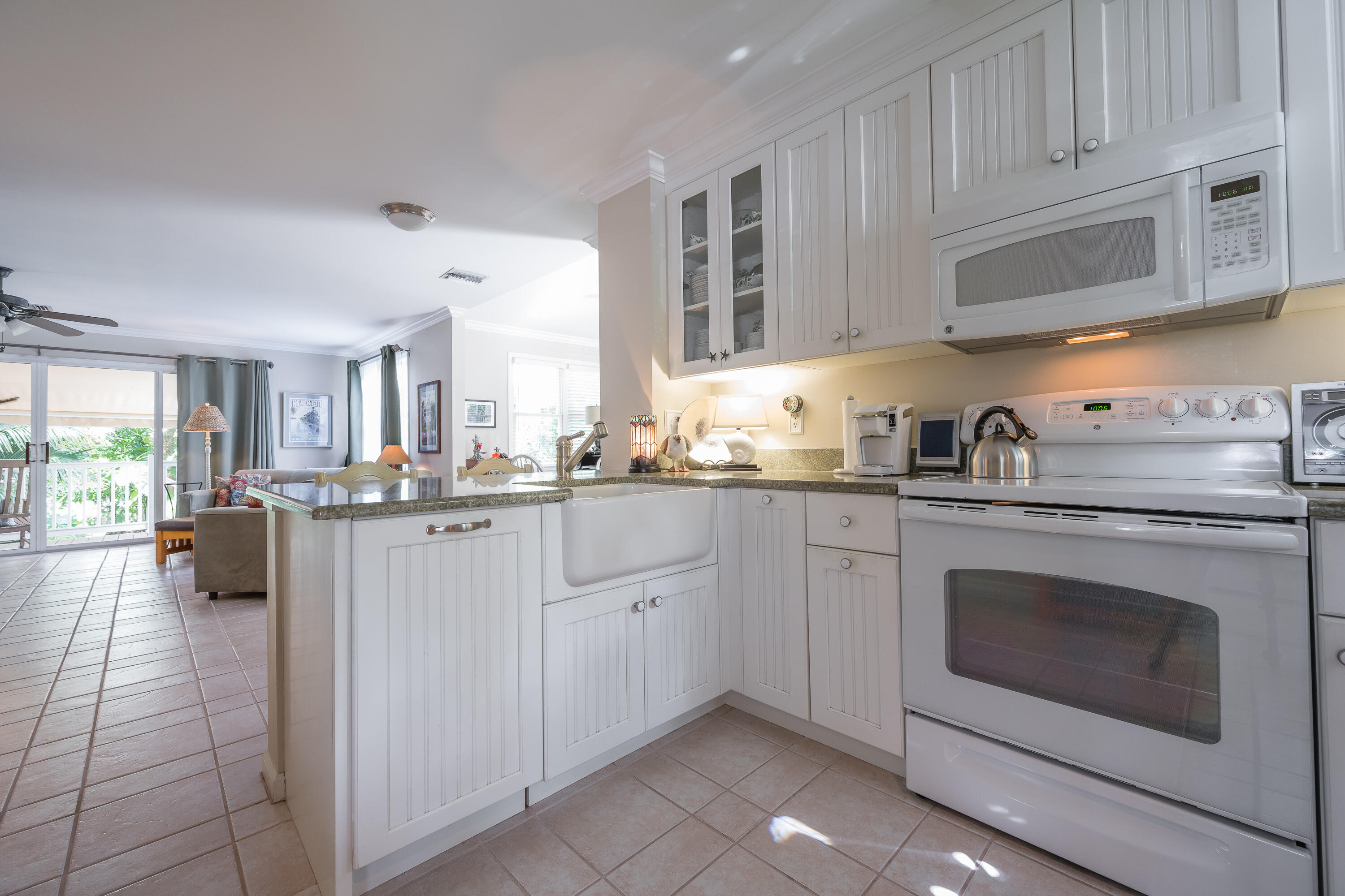 28 Spoonbill Way Key West, FL 33040 - Photo 10 of 82 a kitchen with granite countertop white cabinets stainless steel appliances and sink