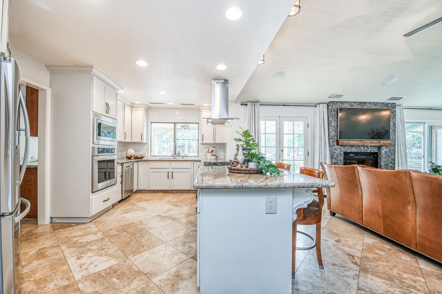 12592 Auberry Road Clovis, CA 93619 - Photo 11 of 65 a kitchen with cabinets and refrigerator