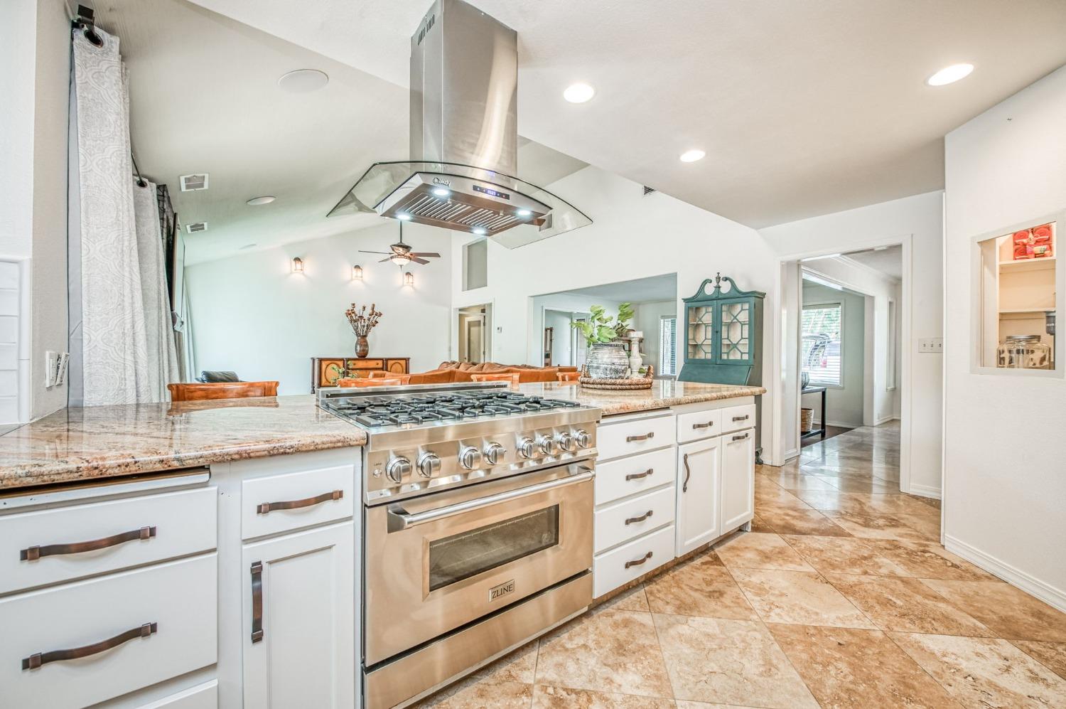 12592 Auberry Road Clovis, CA 93619 - Photo 14 of 65 a kitchen with stainless steel appliances granite countertop a stove and white cabinets