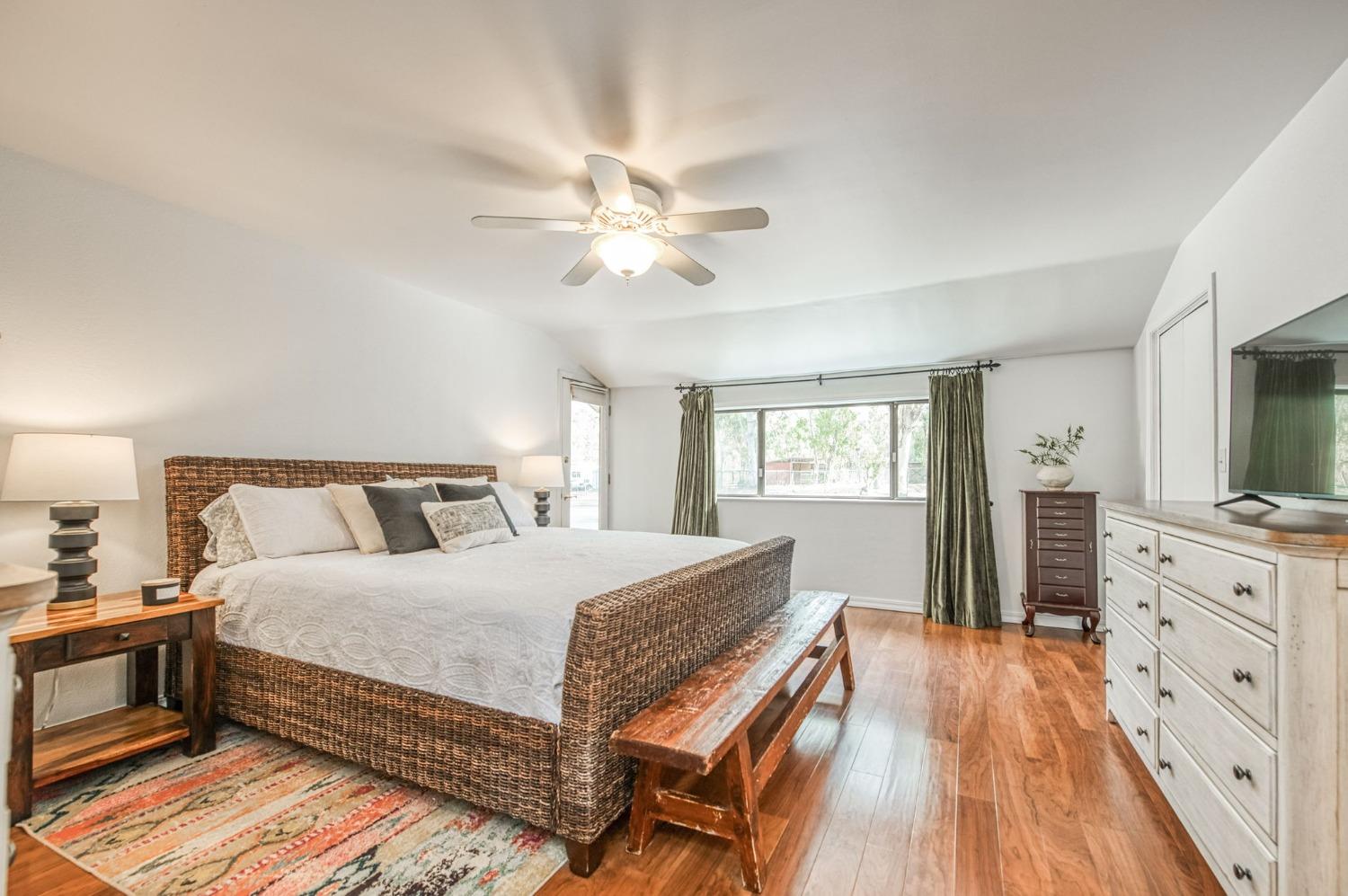 12592 Auberry Road Clovis, CA 93619 - Photo 16 of 65 a bedroom with a large bed and a flat tv screen on dresser
