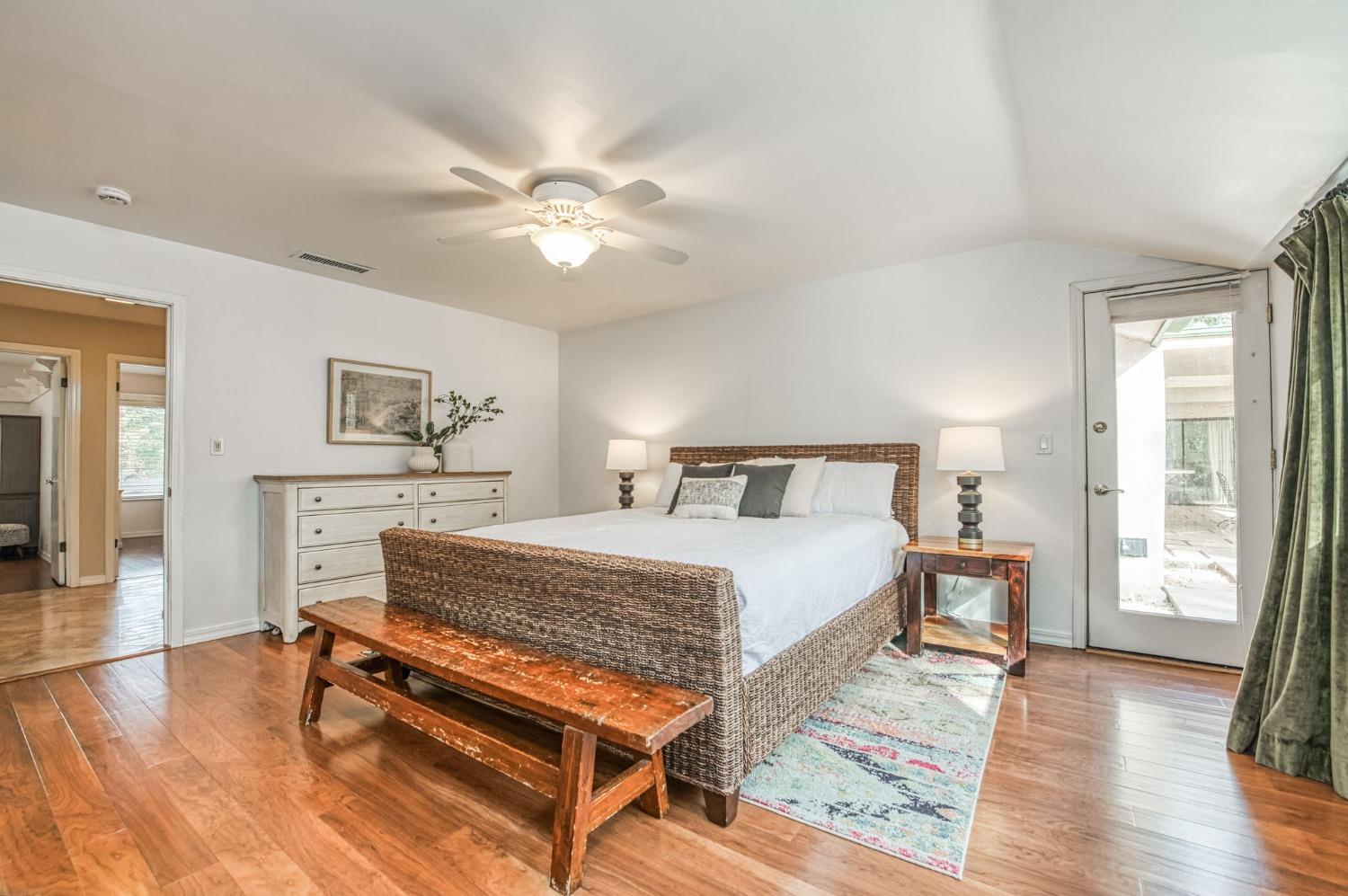 12592 Auberry Road Clovis, CA 93619 - Photo 17 of 65 a bedroom with a bed and wooden floor