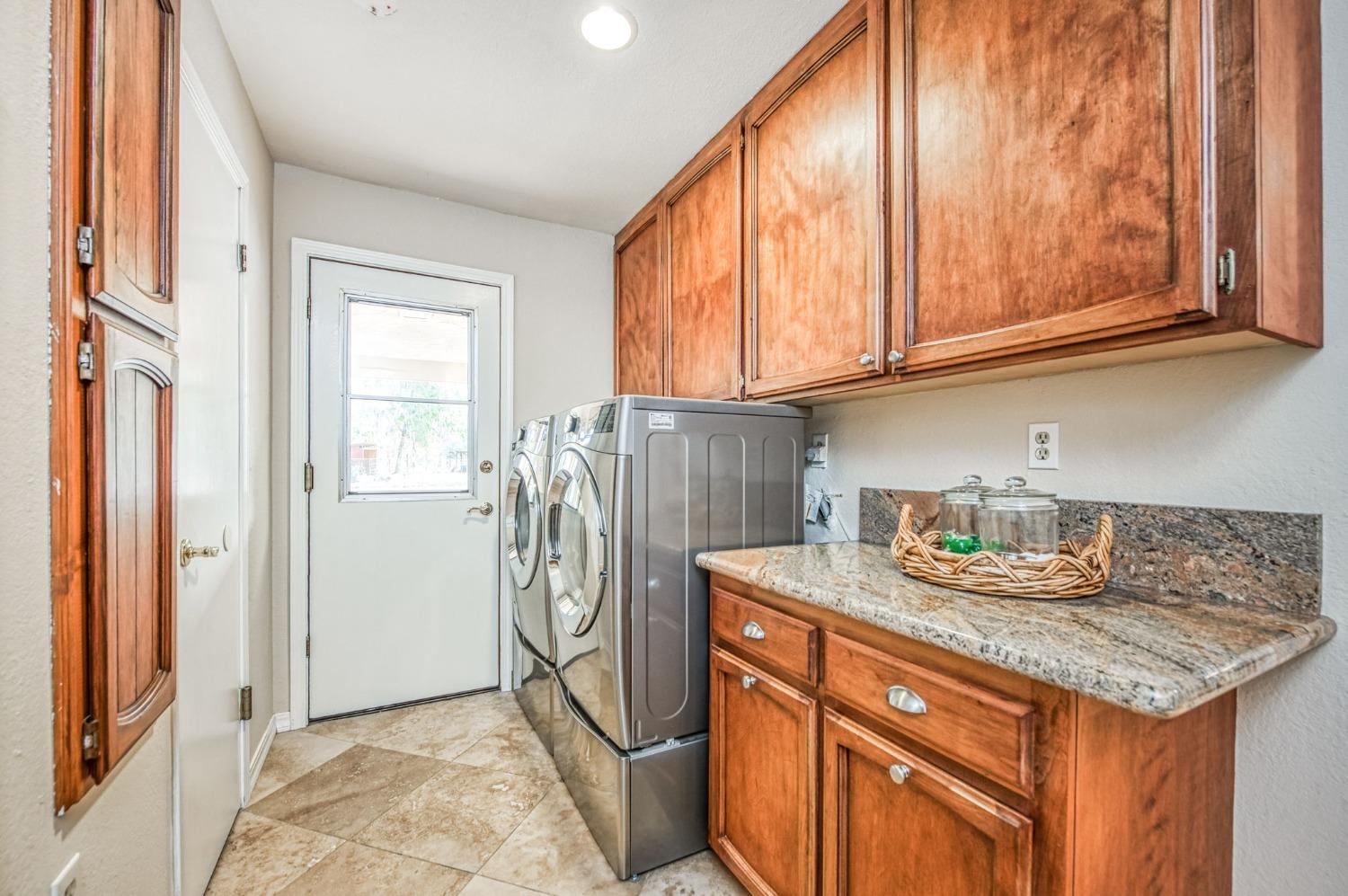 12592 Auberry Road Clovis, CA 93619 - Photo 26 of 65 a kitchen with stainless steel appliances granite countertop a refrigerator and a sink