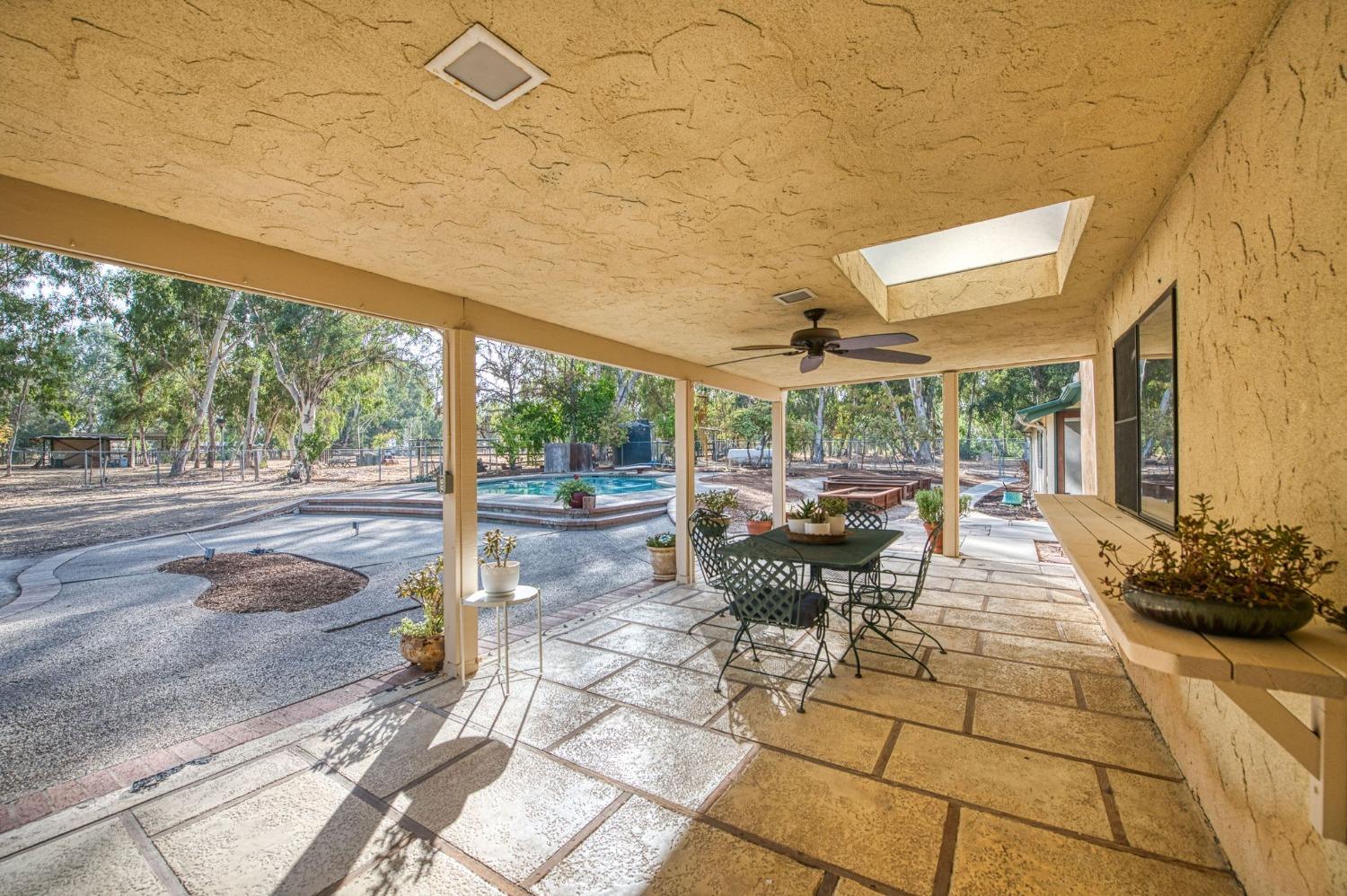 12592 Auberry Road Clovis, CA 93619 - Photo 27 of 65 a view of a patio with table and chairs and potted plants