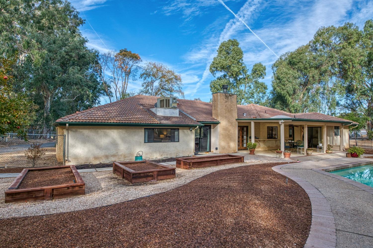 12592 Auberry Road Clovis, CA 93619 - Photo 29 of 65 a backyard of a house with yard table and chairs