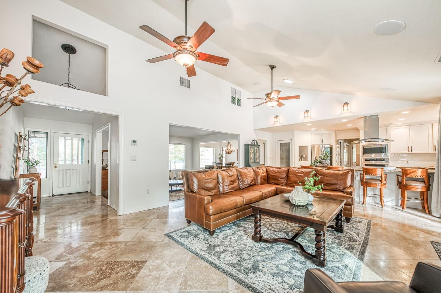 12592 Auberry Road Clovis, CA 93619 - Photo 4 of 65 a living room with furniture ceiling fan and a rug