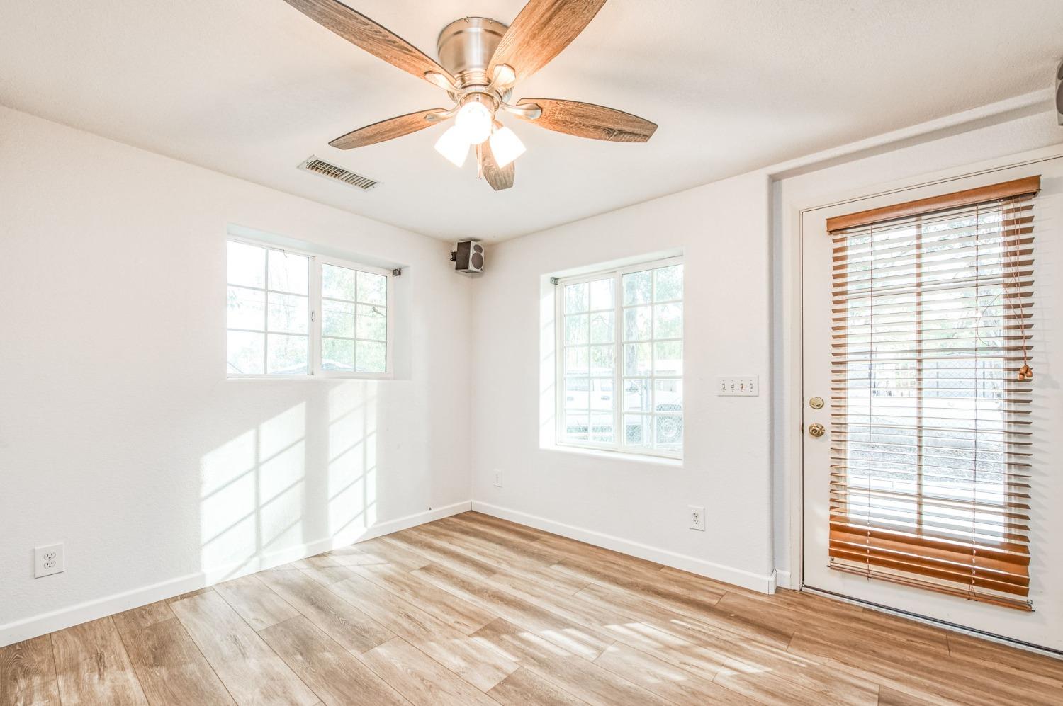 12592 Auberry Road Clovis, CA 93619 - Photo 41 of 65 a view of an empty room with a window and wooden floor