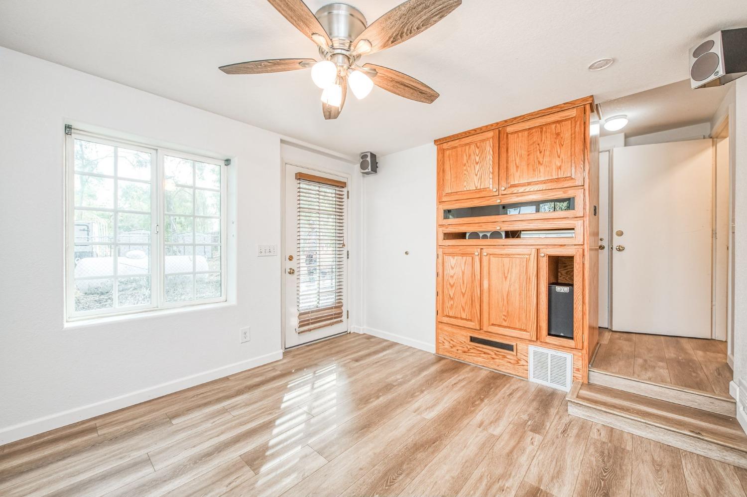 12592 Auberry Road Clovis, CA 93619 - Photo 42 of 65 a view of a livingroom with wooden floor and a ceiling fan