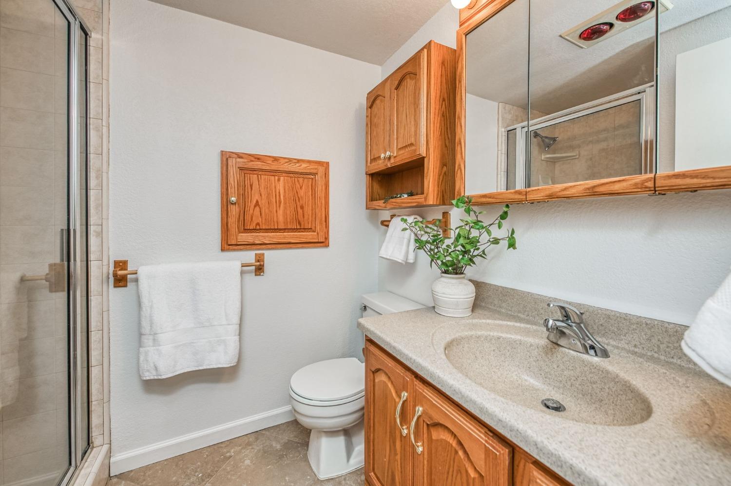 12592 Auberry Road Clovis, CA 93619 - Photo 43 of 65 a bathroom with a granite countertop sink and a mirror