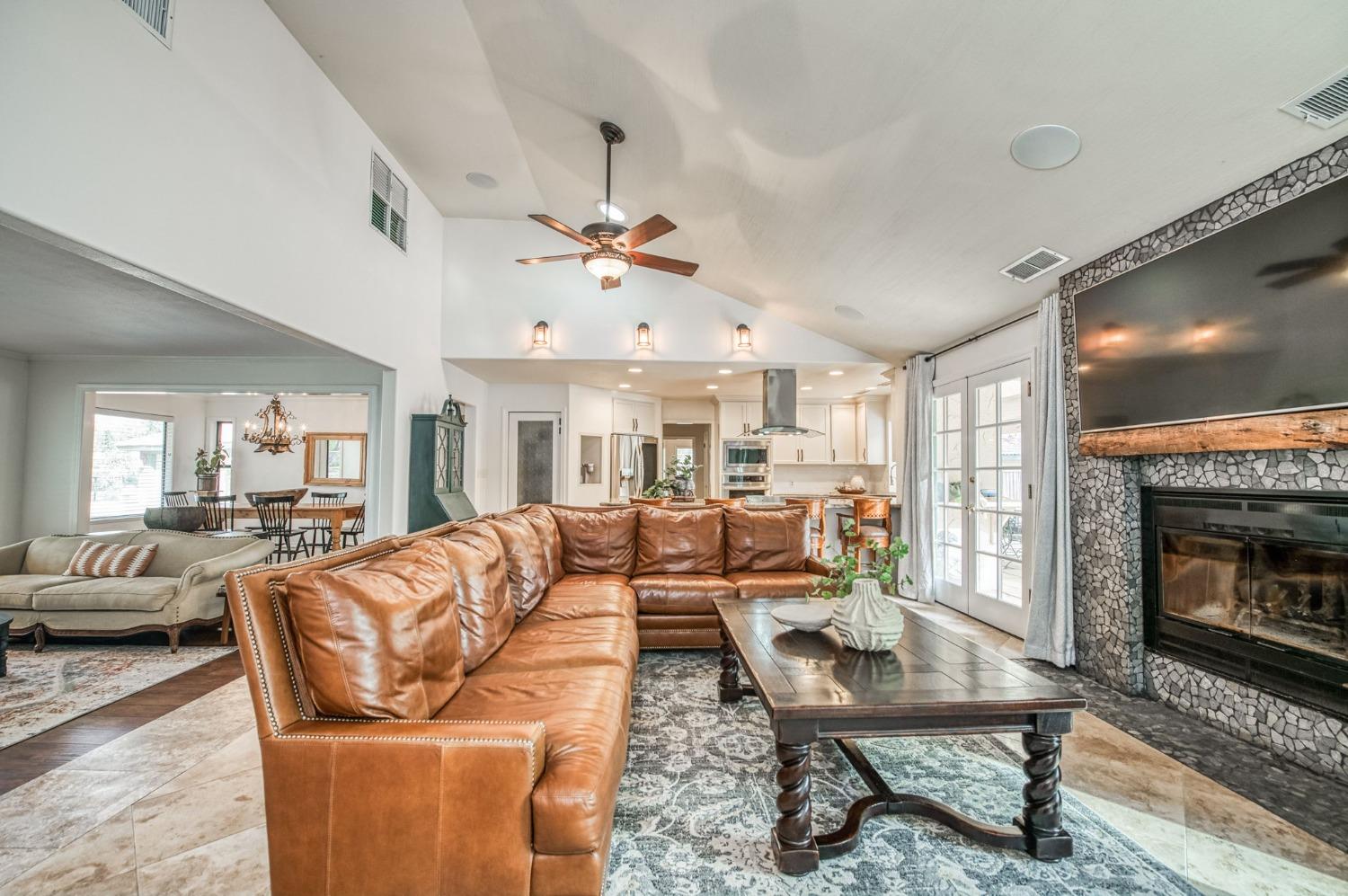 12592 Auberry Road Clovis, CA 93619 - Photo 7 of 65 a living room with furniture a flat screen tv and a fireplace