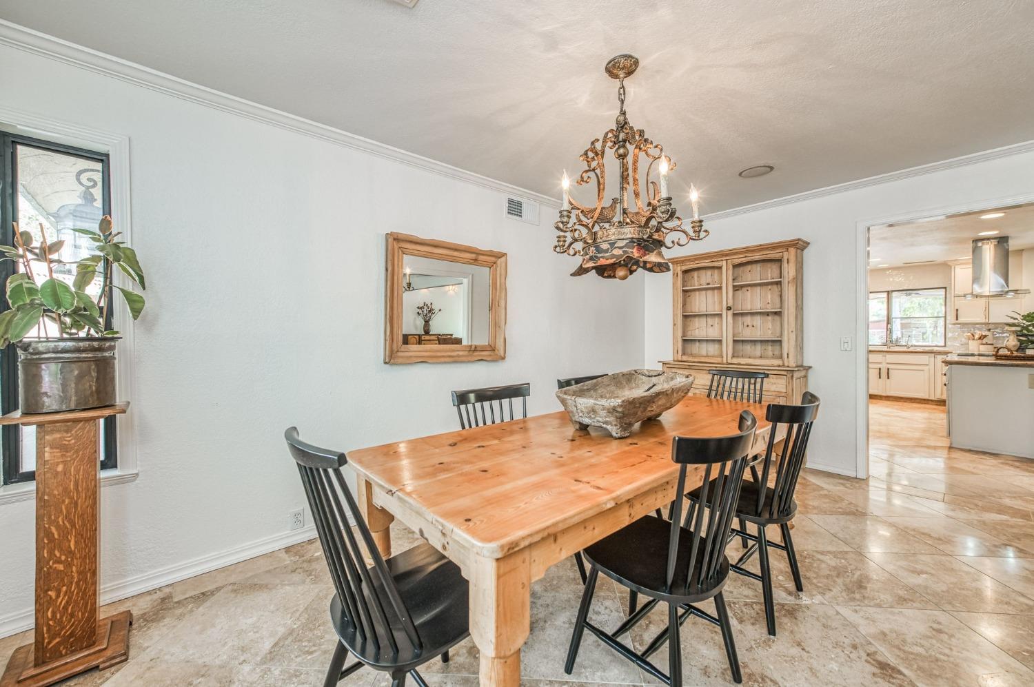 12592 Auberry Road Clovis, CA 93619 - Photo 10 of 65 a view of a dining room with furniture and chandelier