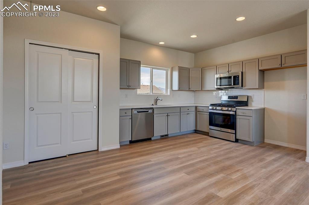11270 Feliz Way Fountain, CO 80817 - Photo 15 of 42 a kitchen with stainless steel appliances granite countertop a stove sink and cabinets