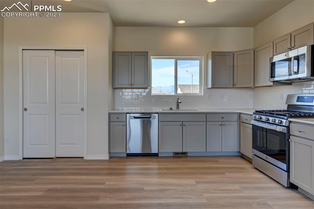 11270 Feliz Way Fountain, CO 80817 - Photo 19 of 42 a kitchen with stainless steel appliances granite countertop a sink a stove a refrigerator and cabinets