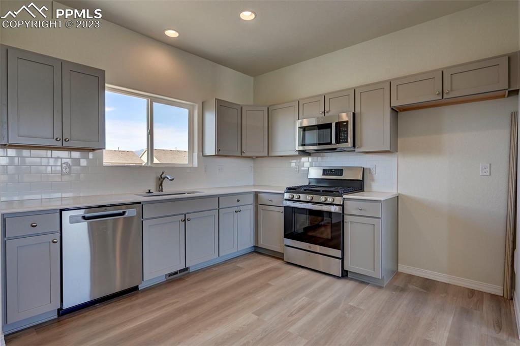 11270 Feliz Way Fountain, CO 80817 - Photo 20 of 42 a kitchen with granite countertop a sink and steel appliances