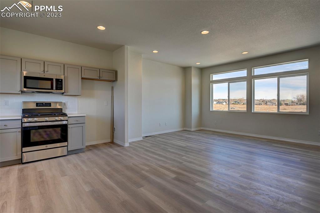 11270 Feliz Way Fountain, CO 80817 - Photo 22 of 42 a kitchen with granite countertop a stove and a refrigerator