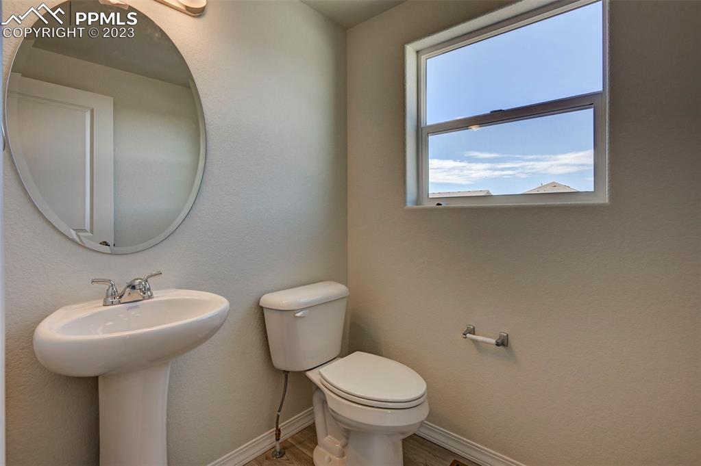 11270 Feliz Way Fountain, CO 80817 - Photo 23 of 42 a bathroom with a toilet sink and mirror