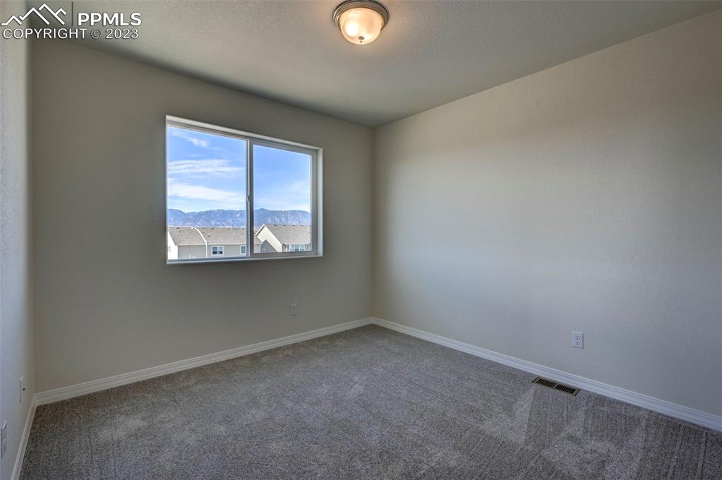 11270 Feliz Way Fountain, CO 80817 - Photo 34 of 42 an empty room with windows